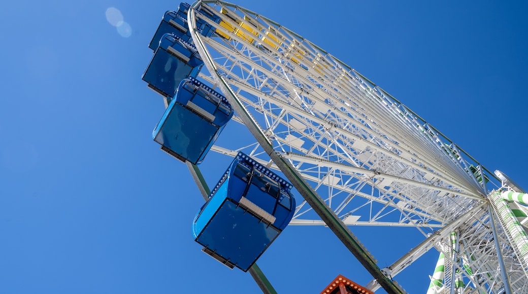 Part of a big colorful vivid ferris wheel on a bright sunny day