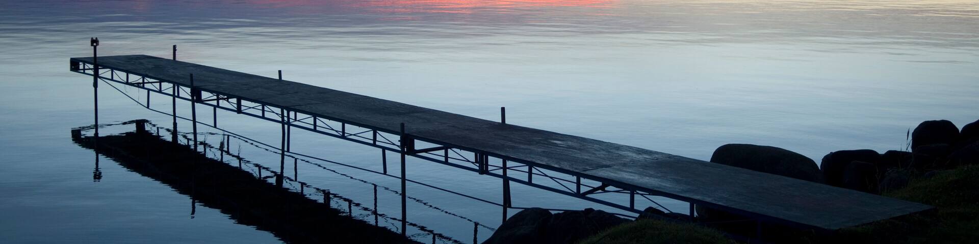 Dock at a lodge on Leech Lake, Minnesota at sundown, USA; Walker, Minnesota, United States of America