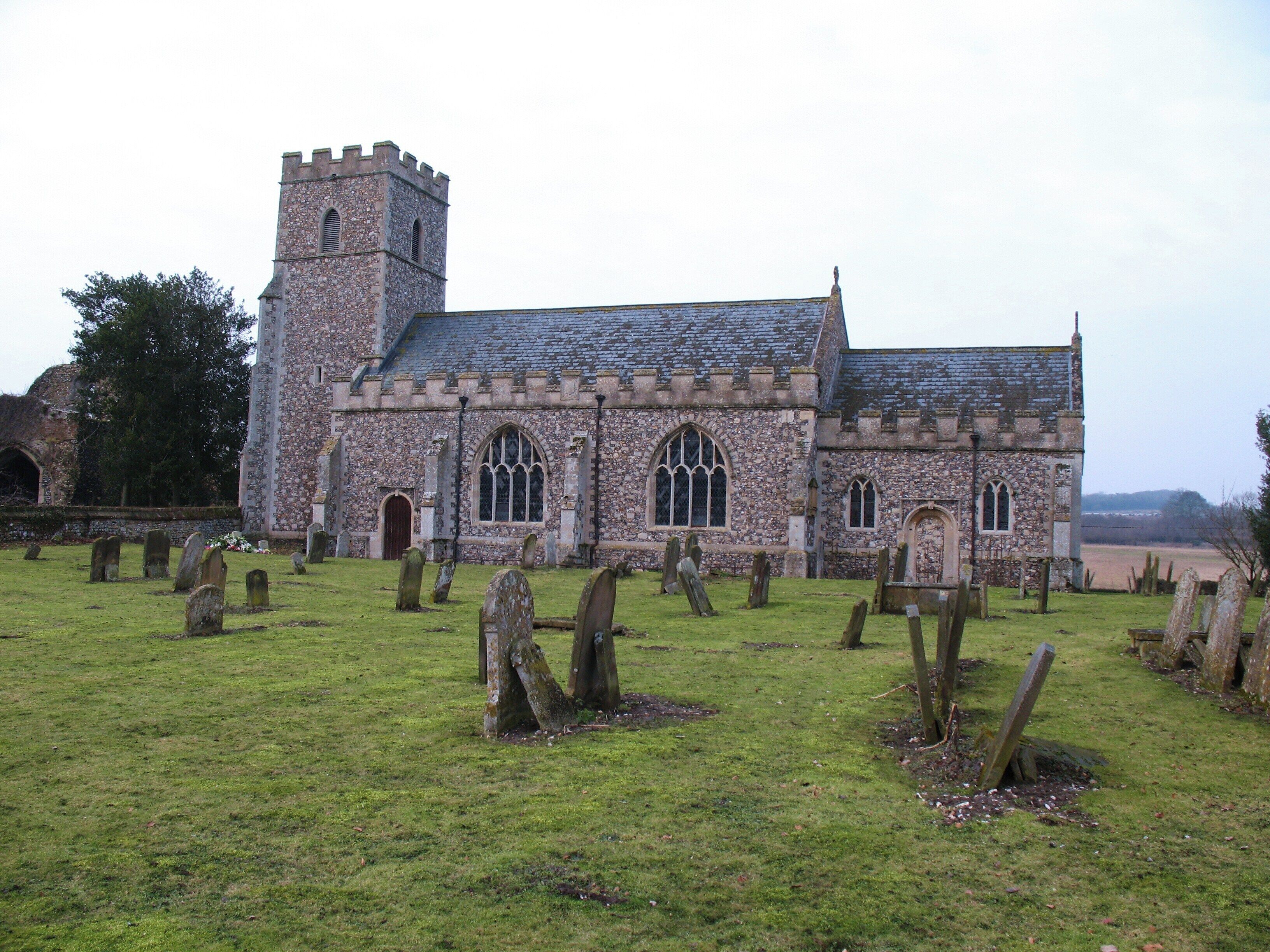 A historic church with a tower and stained glass windows.