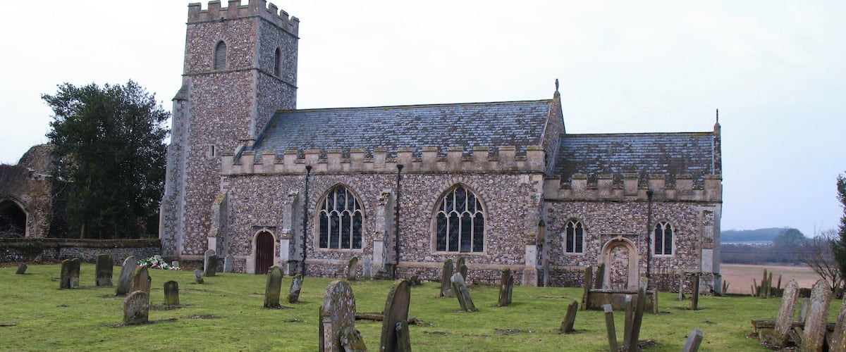 A historic church with a tower and stained glass windows.