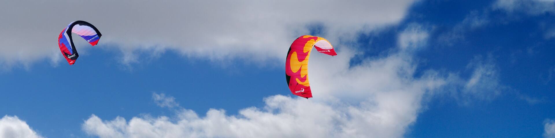 Boarder and skier snowkiting on Lake Simcoe