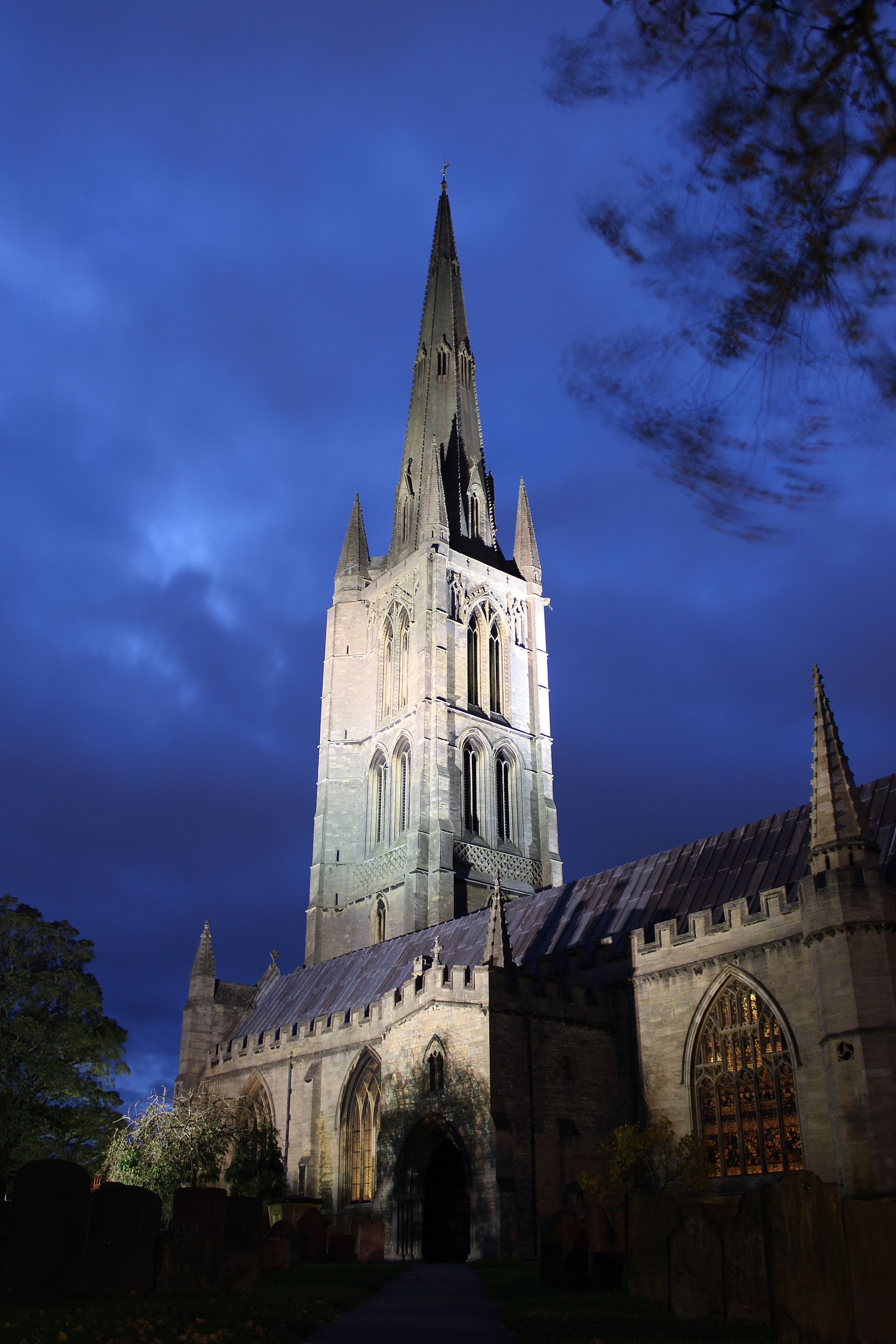 A Gothic-style church with a tall spire and arched windows.