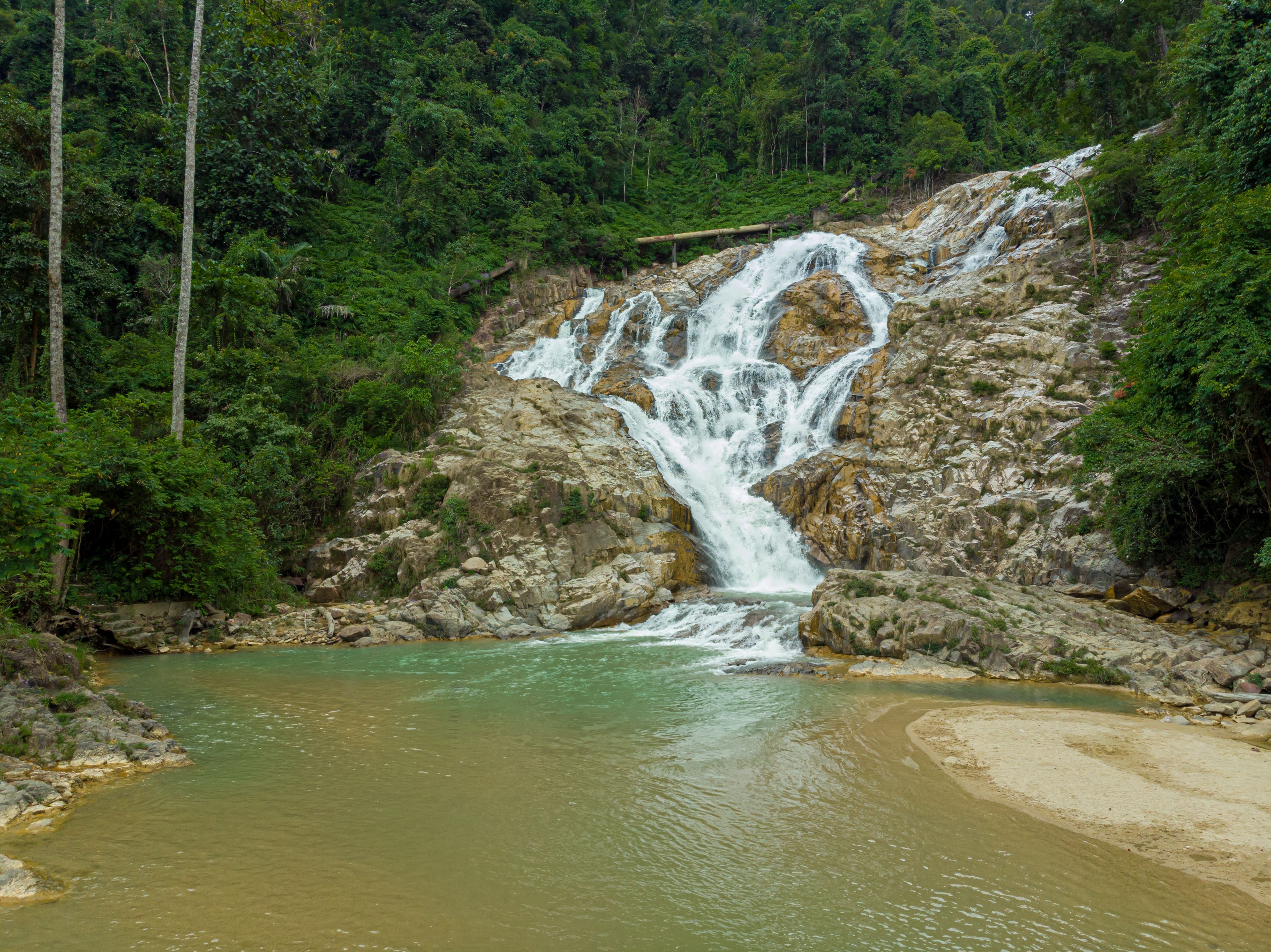 Aerial drone view of beautiful waterfall at Lata Berangin Waterfall, Kuala Krai, Kelantan, Malaysia.