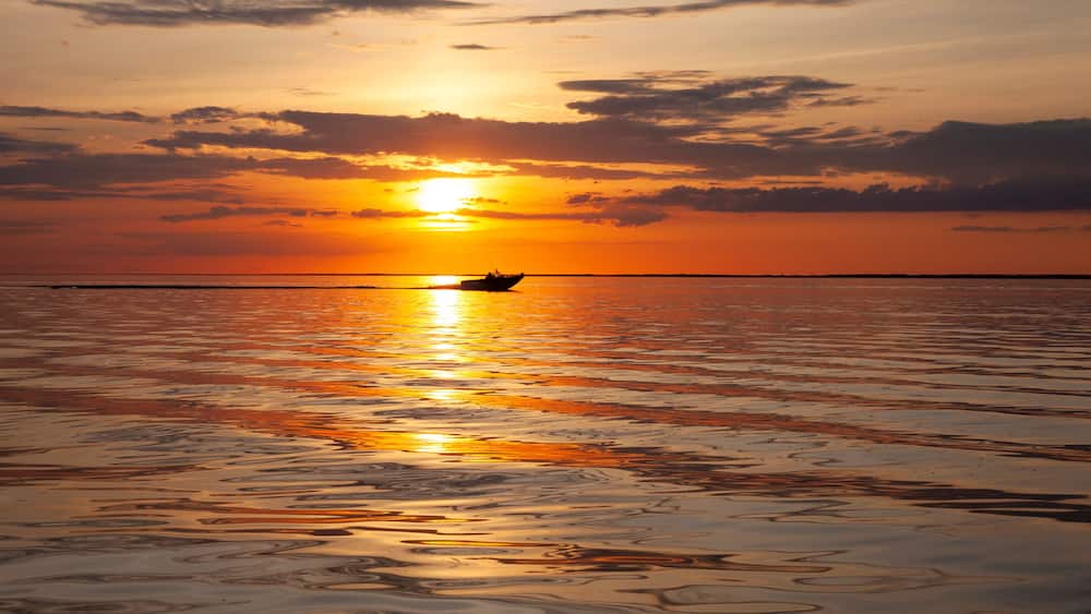 Fishing boat on Upper Red Lake in northern Minnesota heading in at sunset