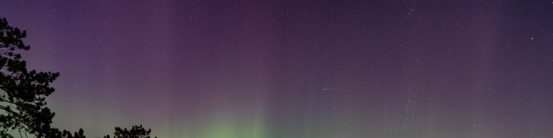 Northern Lights erupt in brilliant Aurora sky over Northern Minnesota Lake near Remer