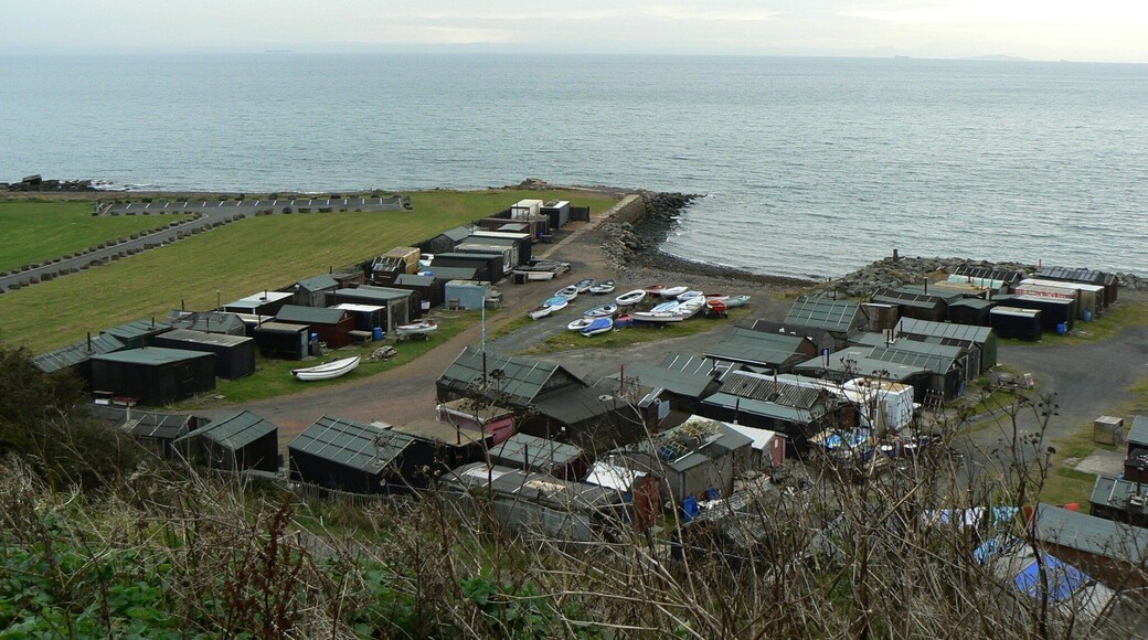 Wee harbour A sheltered landing place for small boats, surrounded by a clutter of old sheds and containers.