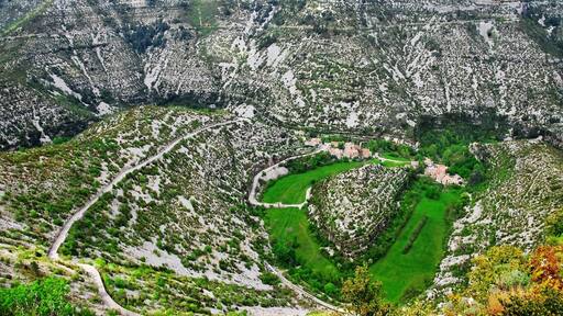 This stunning location is one of the deepest valleys in Europe. You can see the road leading down and it zig-zags up the other side. There's a small village at the bottom but there's a cafe on one lookout that has a wonderful view over this scene. Definitely worth a look if you're in the area.