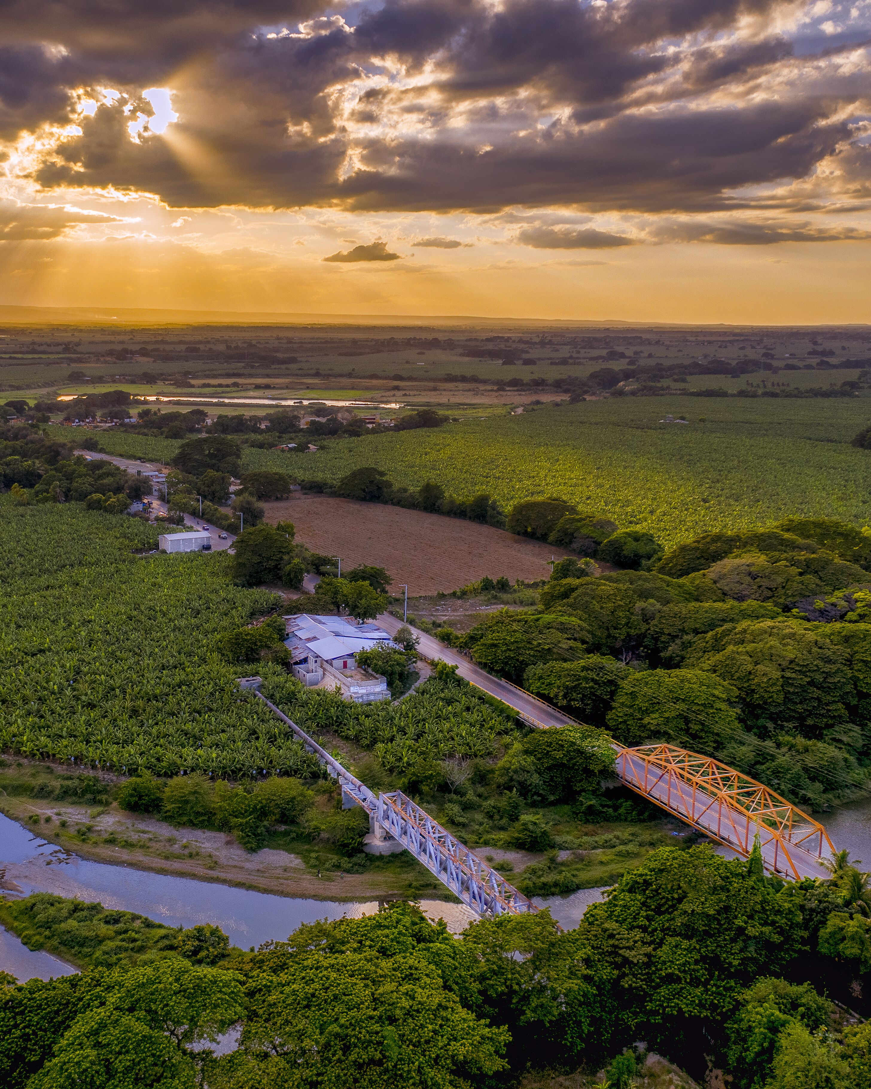 Bridges over a river surrounded by greenery during the sunrise in Mao, the Dominican Republic