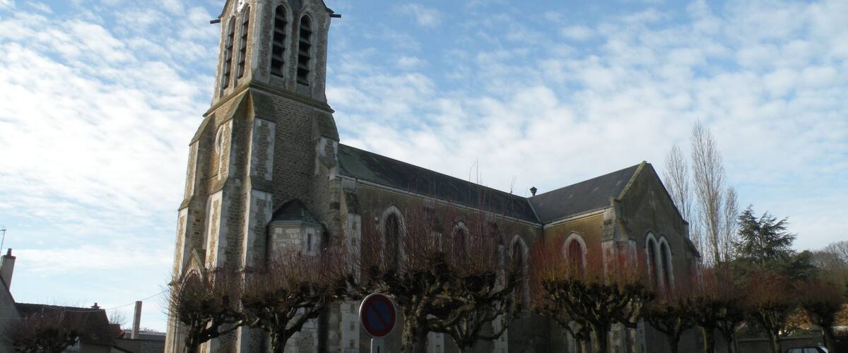 A church with a tall steeple and arched windows.