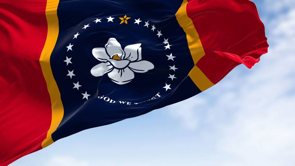 The US state flag of Mississippi waving in the wind