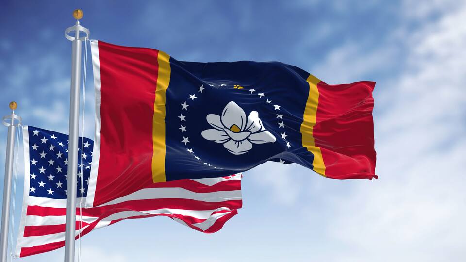 The Mississippi state flag waving along with the national flag of the United States of America