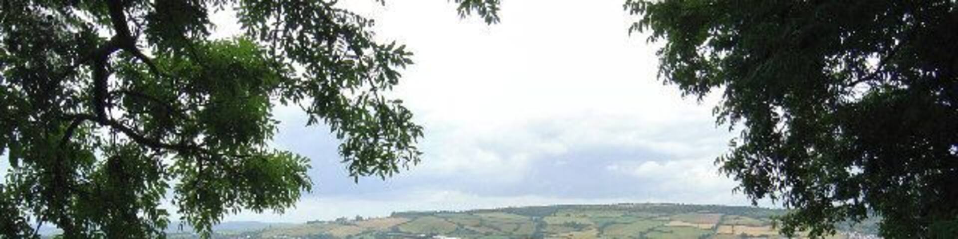 River Teign. Looking down from Butterfly Lane over Ringmore village with the Haldon Hills in the distance
