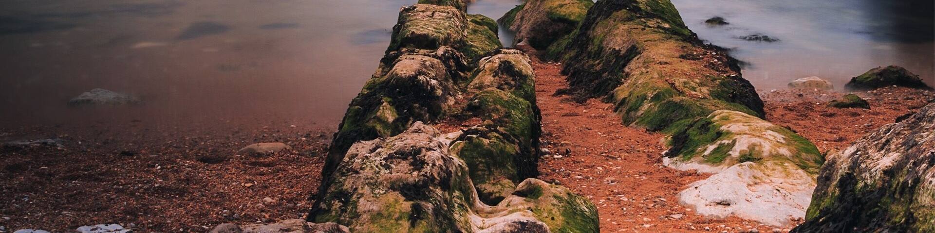 This is on Man of war beach near Durdle door on the Jurassic Coast in UK. Outstanding place with lots of natural beauty and spots for hikes and photography. If you go there wear comfy shoes and be ready for steep (but short) climbs. Enjoy!