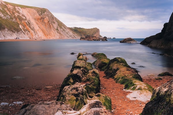This is on Man of war beach near Durdle door on the Jurassic Coast in UK. Outstanding place with lots of natural beauty and spots for hikes and photography. If you go there wear comfy shoes and be ready for steep (but short) climbs. Enjoy!
