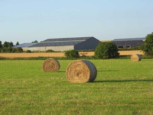 Hay bales and barns, Haxton The buildings are at the crossroads east of the village and viewed from the footpath to the south.