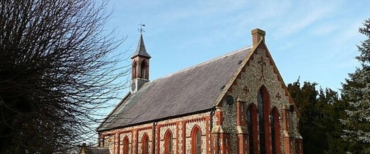 A historic church with a prominent steeple and arched windows.