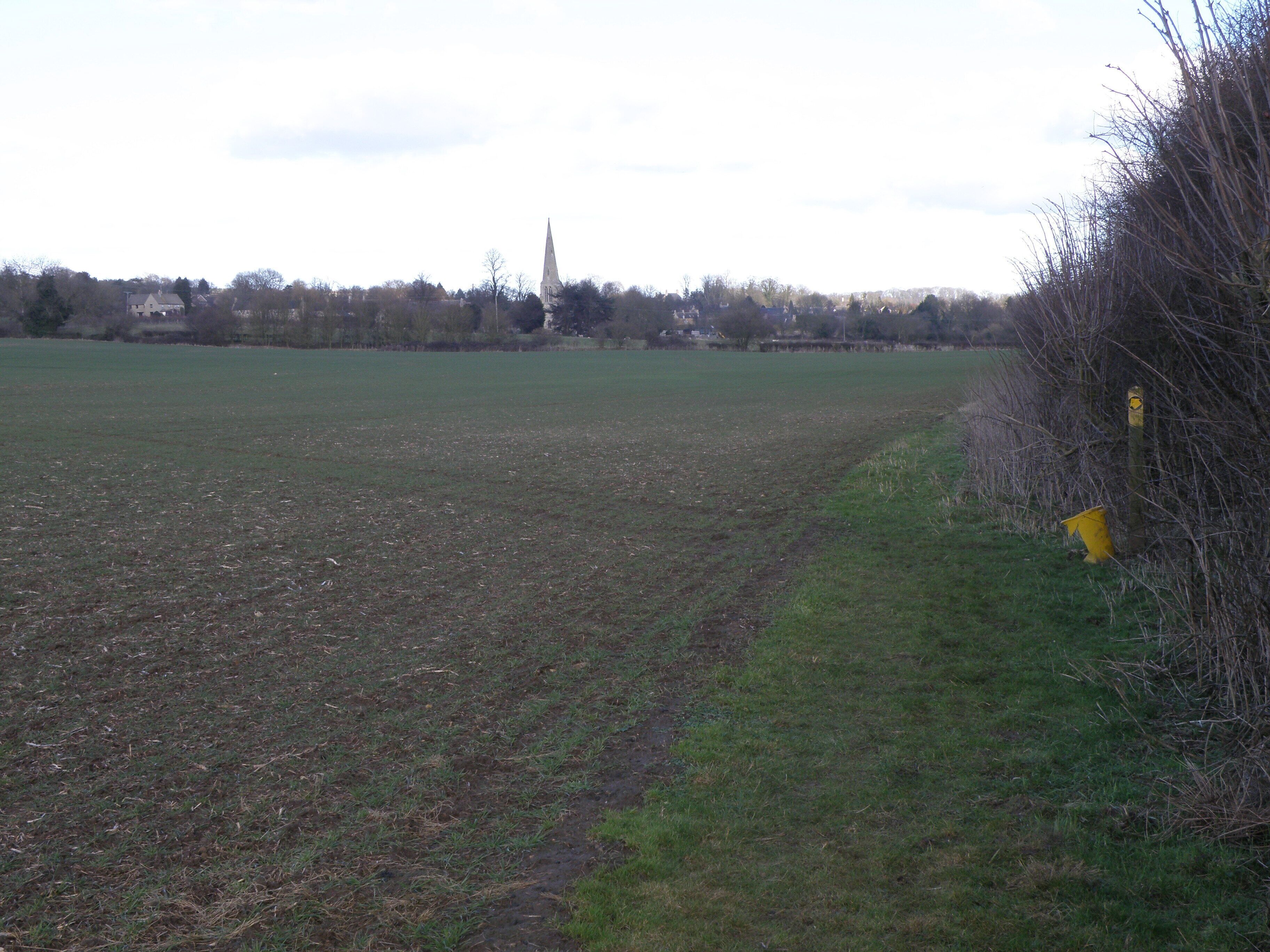 Field edge and marker post for footpath A marker post shows the line of the Jurassic Way near Barrowden.