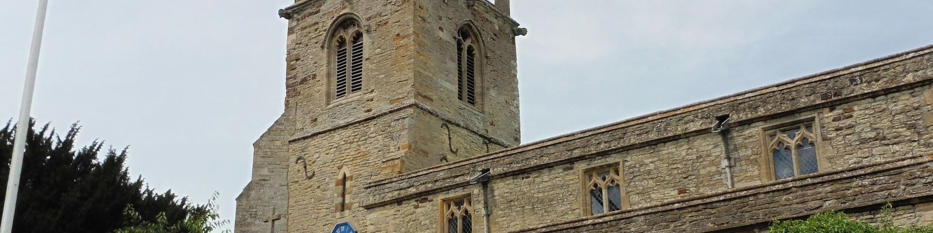 Steeple and south porch of the parish church of St Mary the Virgin, Podington, Bedfordshire, seen from the southeast