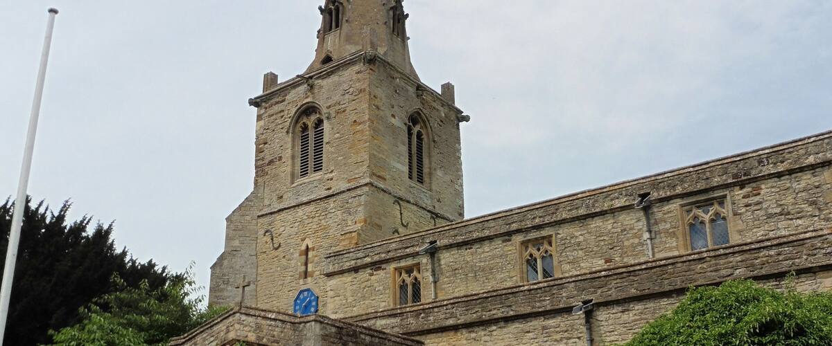 A historic church with a tall spire and a clock.