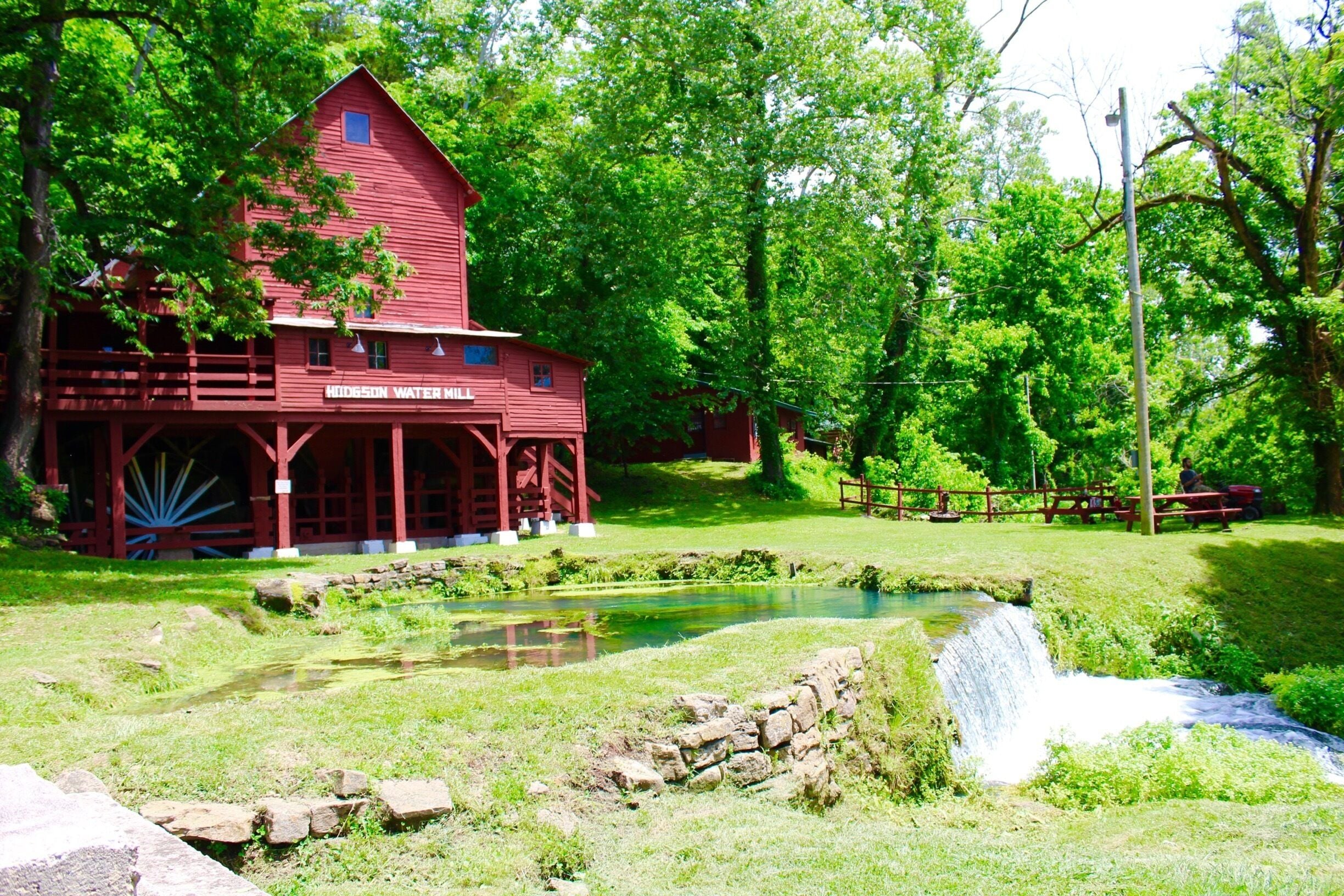 I had been seeing this mill pop up on Facebook and discovered that it was only about an hour away!  Such a beautiful spot.    There are picnic tables, bridges and trails. People swim in the water as well!   A true gem tucked away in the Ozark mountains!

Hodgson Water Mill, only a few minutes away through famous Ozark County scenery. From Dawt, return to PP Hwy. and turn left on PP to H Hwy. Turn left on H and go north to Hwy. 181. Turn left again on Hwy. 181 to Hodgson Mill.
Built in 1861 to harness the power of a massive spring flowing into Bryant Creek and rebuilt in 1897, the tall, three-story frame building nestles against a bluff of the Bryant. Though the mill no longer grinds grain, it still houses the old milling machinery. (The nationally distributed line of stone-ground bakery products bearing the Hodgson name is now produced at a modern mill in nearby Gainesville.)

The spring still spews nearly 3,000,000 gallons of clear, cold water a day. Besides the mill, it once powered a cotton gin, a lumber mill, and a clothing factory. In pre-REA days, the power of the water also generated electricity for all the mill-site enterprises. And, once upon a time, thanks to the constant 58 degree temperature of the spring, the mill was a popular site for neighborhood dances.

Issuing from the bluff under the mill building, the spring is still picturesque. It nourishes native ferns and mosses clinging to crevices in the sheer rock wall. Some of the water is diverted to the mill pond, where watercress and other marine plants thrive. Inside the mill building, an opening to a cave in the face of the bluff provides natural air conditioning.

A modern day facility in nearby Gainesville, MO is still producing and distributing the all natural stone ground flours of the past under the Hodgson Mill name.

#LIFEATEXPEDIA #WATERMILL #LOCALSIGHTS #OZARKMOUNTAINS #IHEARTTHEOZARKS