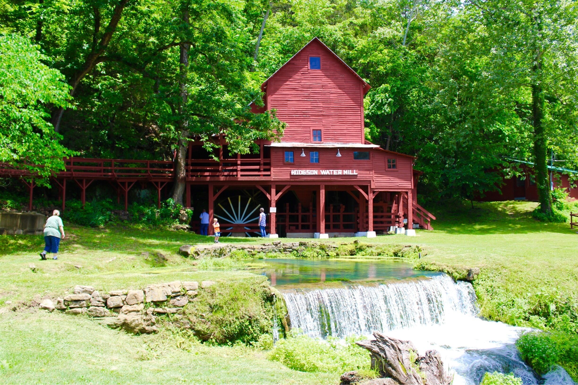 I had been seeing this mill pop up on Facebook and discovered that it was only about an hour away!  Such a beautiful spot.    There are picnic tables, bridges and trails. People swim in the water as well!   A true gem tucked away in the Ozark mountains!

Hodgson Water Mill, only a few minutes away through famous Ozark County scenery. From Dawt, return to PP Hwy. and turn left on PP to H Hwy. Turn left on H and go north to Hwy. 181. Turn left again on Hwy. 181 to Hodgson Mill.
Built in 1861 to harness the power of a massive spring flowing into Bryant Creek and rebuilt in 1897, the tall, three-story frame building nestles against a bluff of the Bryant. Though the mill no longer grinds grain, it still houses the old milling machinery. (The nationally distributed line of stone-ground bakery products bearing the Hodgson name is now produced at a modern mill in nearby Gainesville.)

The spring still spews nearly 3,000,000 gallons of clear, cold water a day. Besides the mill, it once powered a cotton gin, a lumber mill, and a clothing factory. In pre-REA days, the power of the water also generated electricity for all the mill-site enterprises. And, once upon a time, thanks to the constant 58 degree temperature of the spring, the mill was a popular site for neighborhood dances.

Issuing from the bluff under the mill building, the spring is still picturesque. It nourishes native ferns and mosses clinging to crevices in the sheer rock wall. Some of the water is diverted to the mill pond, where watercress and other marine plants thrive. Inside the mill building, an opening to a cave in the face of the bluff provides natural air conditioning.

A modern day facility in nearby Gainesville, MO is still producing and distributing the all natural stone ground flours of the past under the Hodgson Mill name.

#LIFEATEXPEDIA #WATERMILL #LOCALSIGHTS #OZARKMOUNTAINS #IHEARTTHEOZARKS
