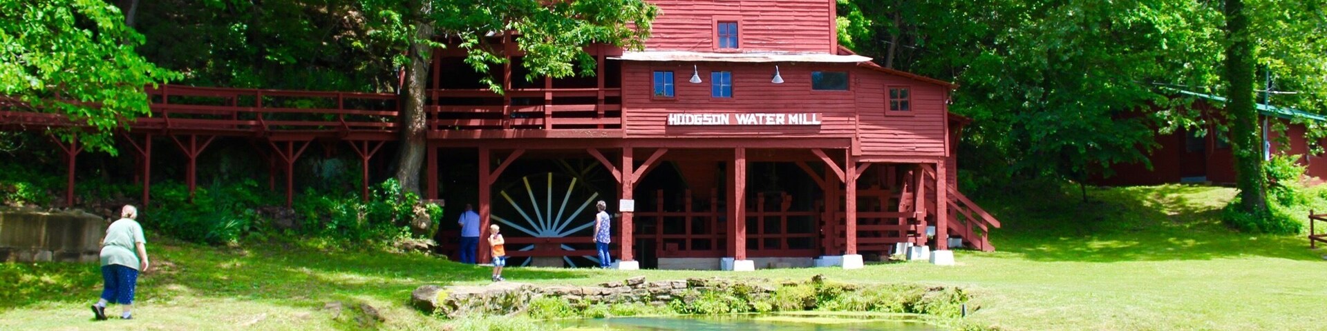 I had been seeing this mill pop up on Facebook and discovered that it was only about an hour away! Such a beautiful spot. There are picnic tables, bridges and trails. People swim in the water as well! A true gem tucked away in the Ozark mountains!
Hodgson Water Mill, only a few minutes away through famous Ozark County scenery. From Dawt, return to PP Hwy. and turn left on PP to H Hwy. Turn left on H and go north to Hwy. 181. Turn left again on Hwy. 181 to Hodgson Mill.
Built in 1861 to harness the power of a massive spring flowing into Bryant Creek and rebuilt in 1897, the tall, three-story frame building nestles against a bluff of the Bryant. Though the mill no longer grinds grain, it still houses the old milling machinery. (The nationally distributed line of stone-ground bakery products bearing the Hodgson name is now produced at a modern mill in nearby Gainesville.)
The spring still spews nearly 3,000,000 gallons of clear, cold water a day. Besides the mill, it once powered a cotton gin, a lumber mill, and a clothing factory. In pre-REA days, the power of the water also generated electricity for all the mill-site enterprises. And, once upon a time, thanks to the constant 58 degree temperature of the spring, the mill was a popular site for neighborhood dances.
Issuing from the bluff under the mill building, the spring is still picturesque. It nourishes native ferns and mosses clinging to crevices in the sheer rock wall. Some of the water is diverted to the mill pond, where watercress and other marine plants thrive. Inside the mill building, an opening to a cave in the face of the bluff provides natural air conditioning.
A modern day facility in nearby Gainesville, MO is still producing and distributing the all natural stone ground flours of the past under the Hodgson Mill name.
#LIFEATEXPEDIA #WATERMILL #LOCALSIGHTS #OZARKMOUNTAINS #IHEARTTHEOZARKS