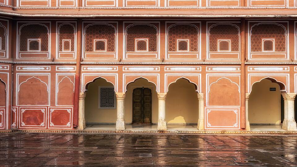A traditional Indian building with intricate architectural details, including arched doorways and decorative patterns.