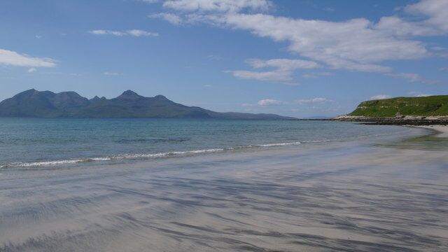 Cleadale Beach Looking to the Island of Rum. The beach had what looked to be streaks of black volcanic sand as well as the obvious white sand