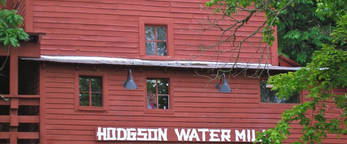 A red building with the sign "Hodgson Water Mill".