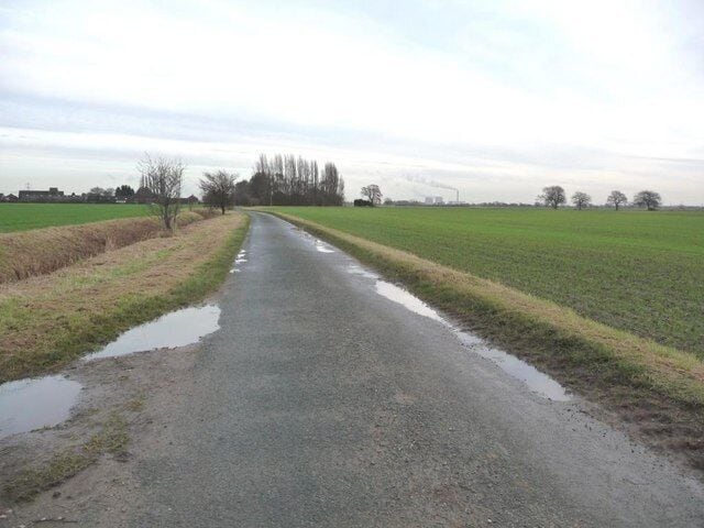 Looking east along Burton Common Lane On the horizon is Burton Common Farm [left] and Eggborough power station [centre right].