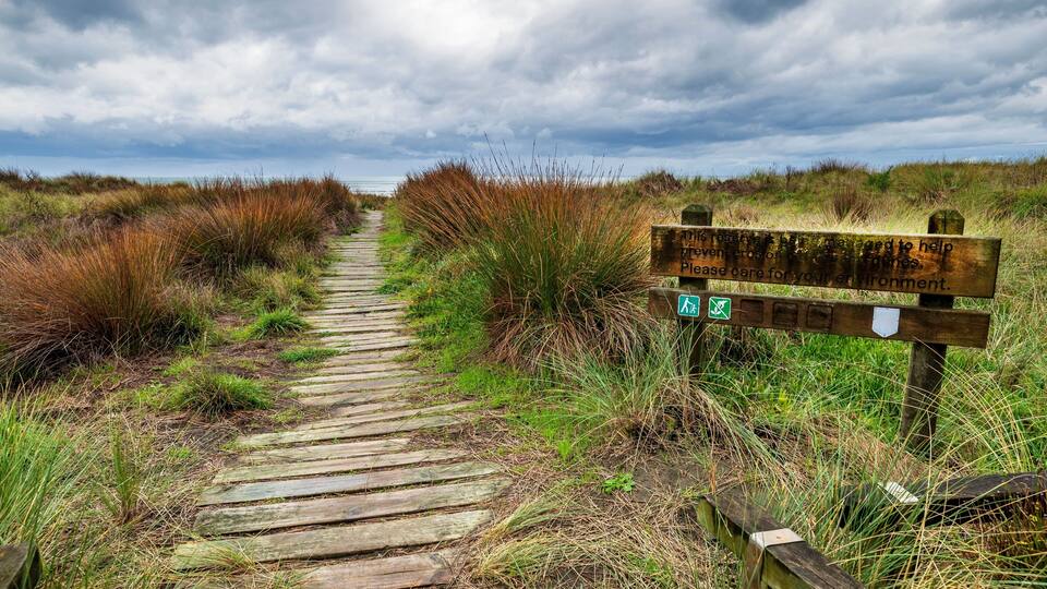 Boardwalk access and sign on Waitarere beach in Manawatu near Levin in New Zealand