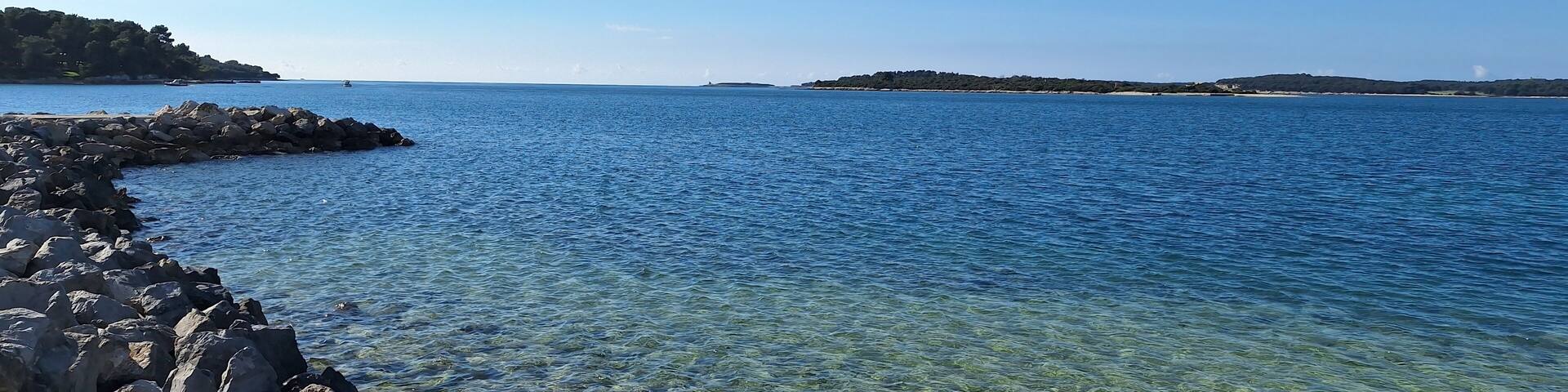 Pula, Croatia - November 3, 2024: Sea close-up. Pebbles on the beach