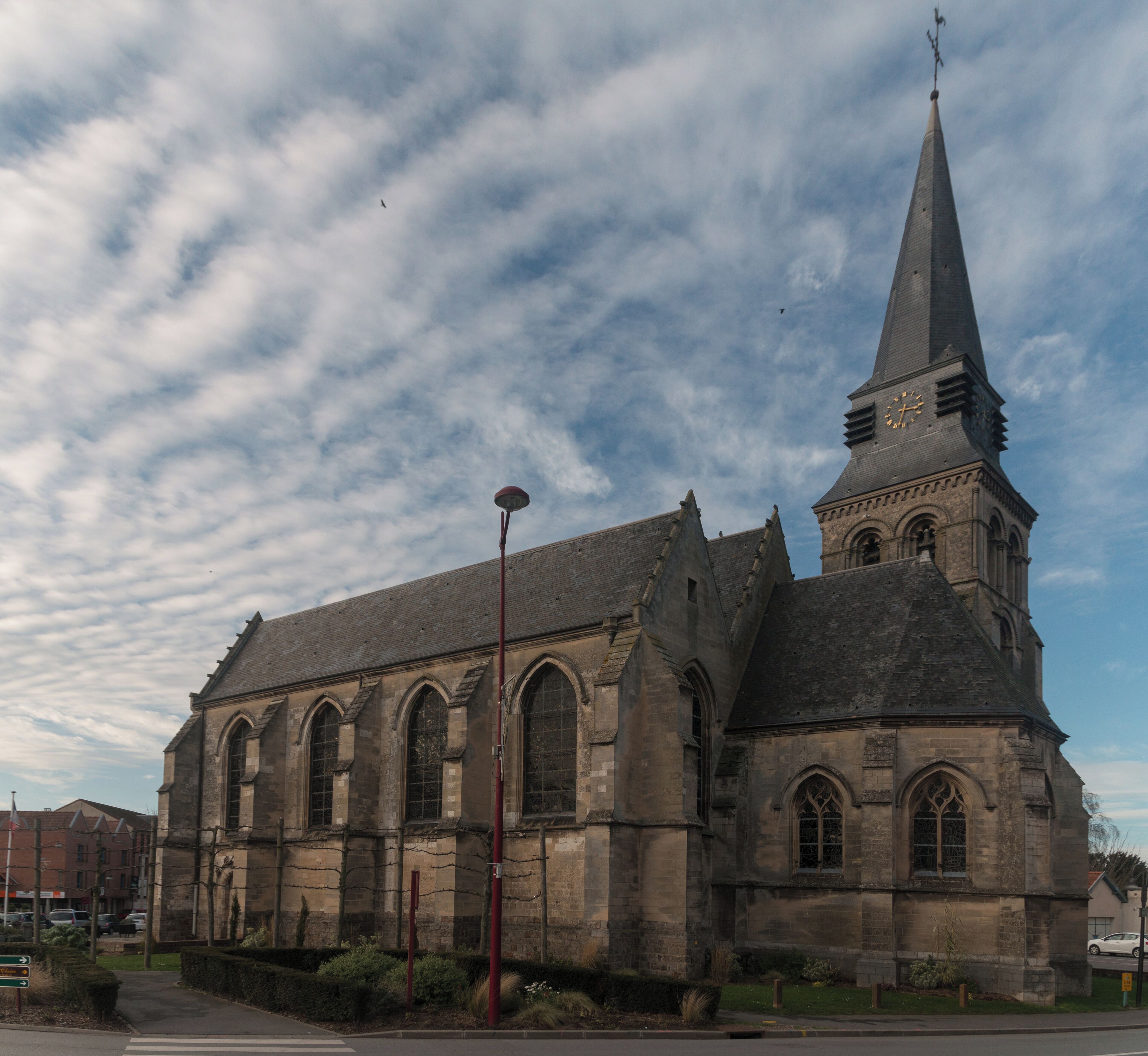 A historic church with a tall steeple and a clock.