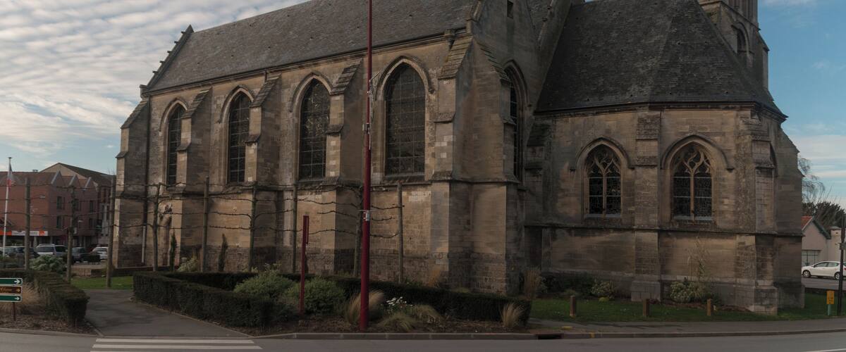 A historic church with a tall steeple and a clock.