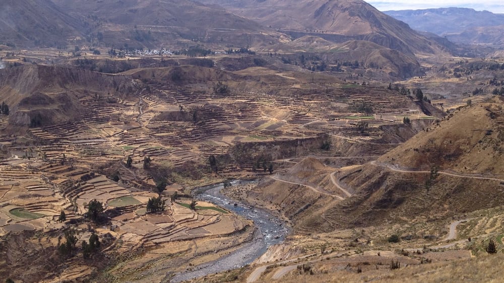 Terraced fields, a river, and mountains.