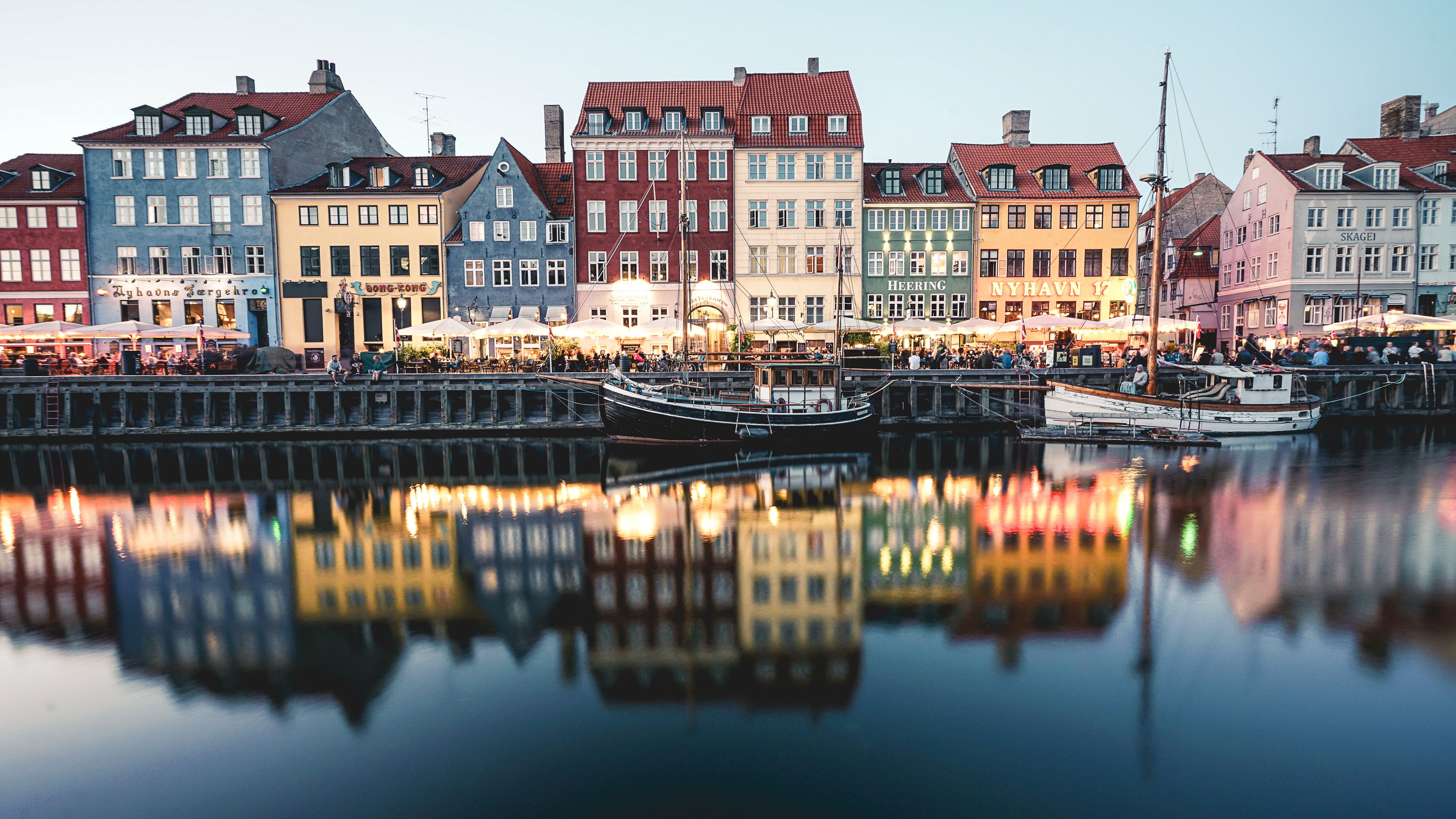 A waterfront with colorful buildings and boats docked.
