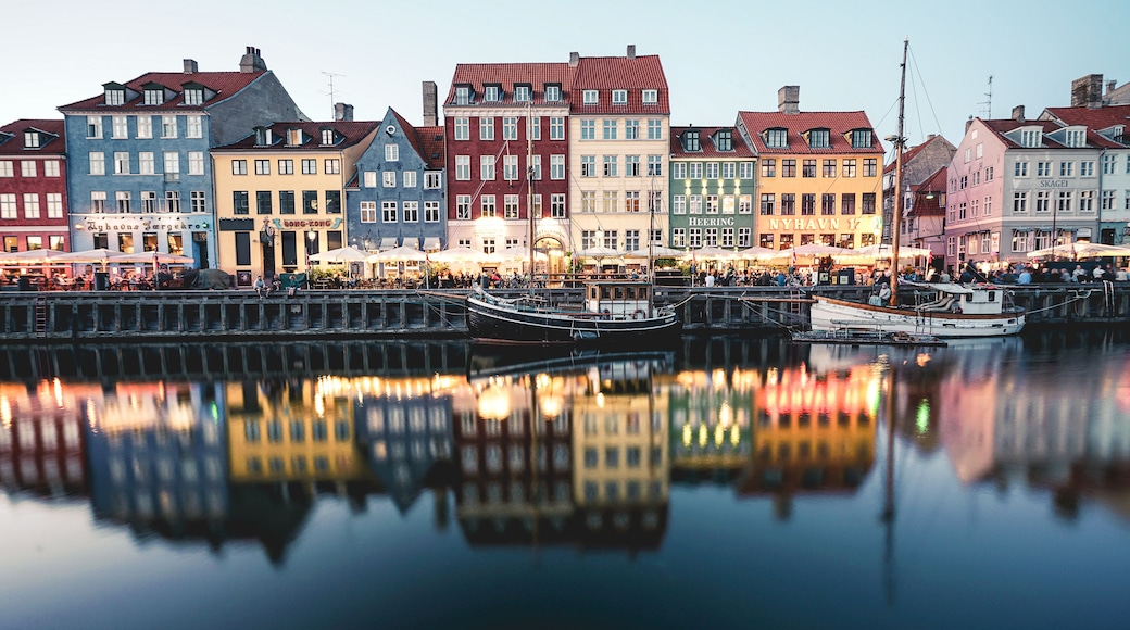 A waterfront with colorful buildings and boats docked.