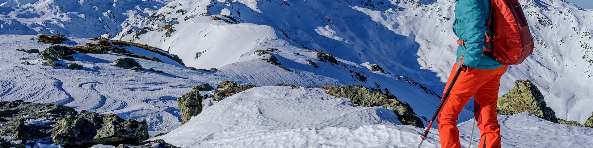 Mature woman with back pack skiing on snowcapped Kastenwendenkopf, Kitzbuehel Alps, Tyrol, Austria