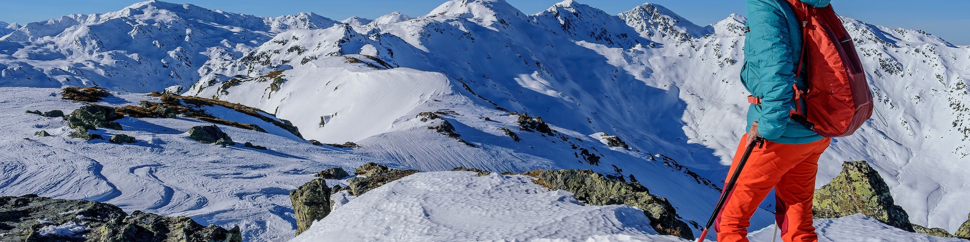 Mature woman with back pack skiing on snowcapped Kastenwendenkopf, Kitzbuehel Alps, Tyrol, Austria