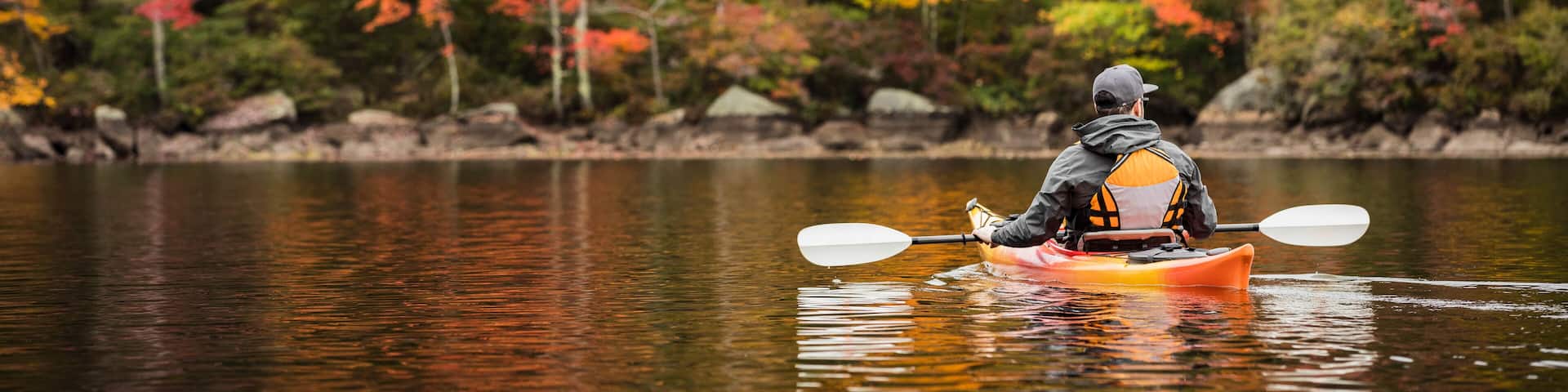 Kayaker on Island Pond Surrounded by Autumn Color