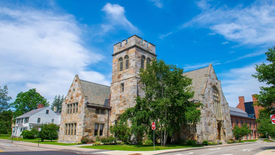 A historic stone church with a prominent tower and arched windows.