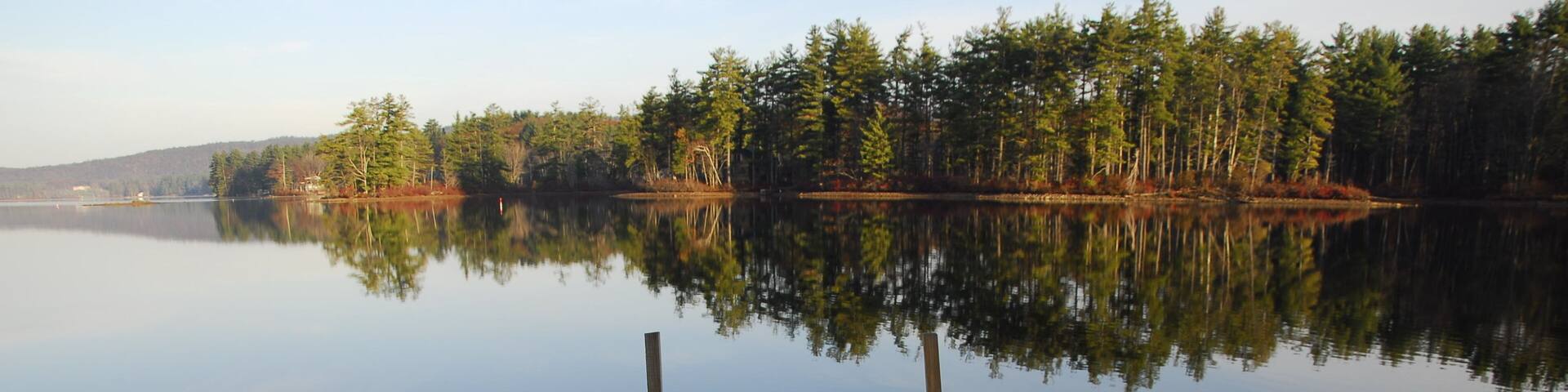 Enjoying the view of the morning reflections from the dock, Bow Lake, Strafford, New Hampshire
