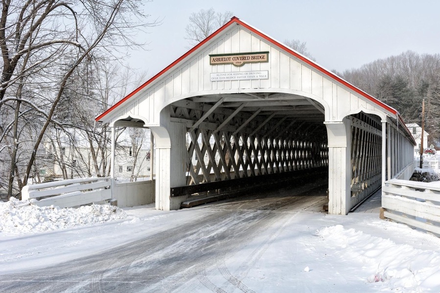 The Ashuelot Covered Bridge is a historic wooden covered bridge over the Ashuelot River on Bolton Road, just south of its intersection with NH 119 in Ashuelot, New Hampshire, an unincorporated village of Winchester.
