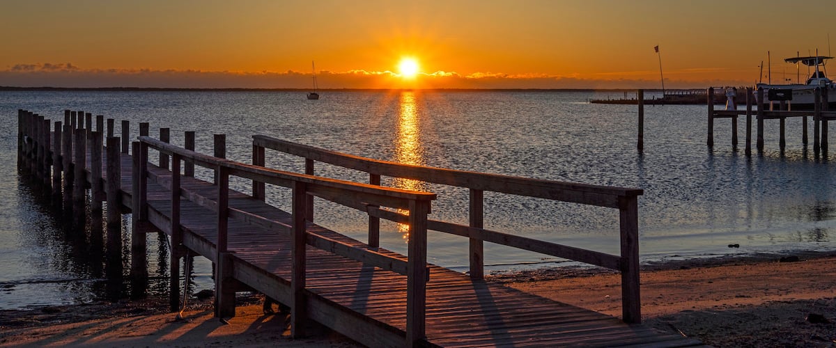 A Public Dock At Sunrise Time On Barnegat Bay In NJ