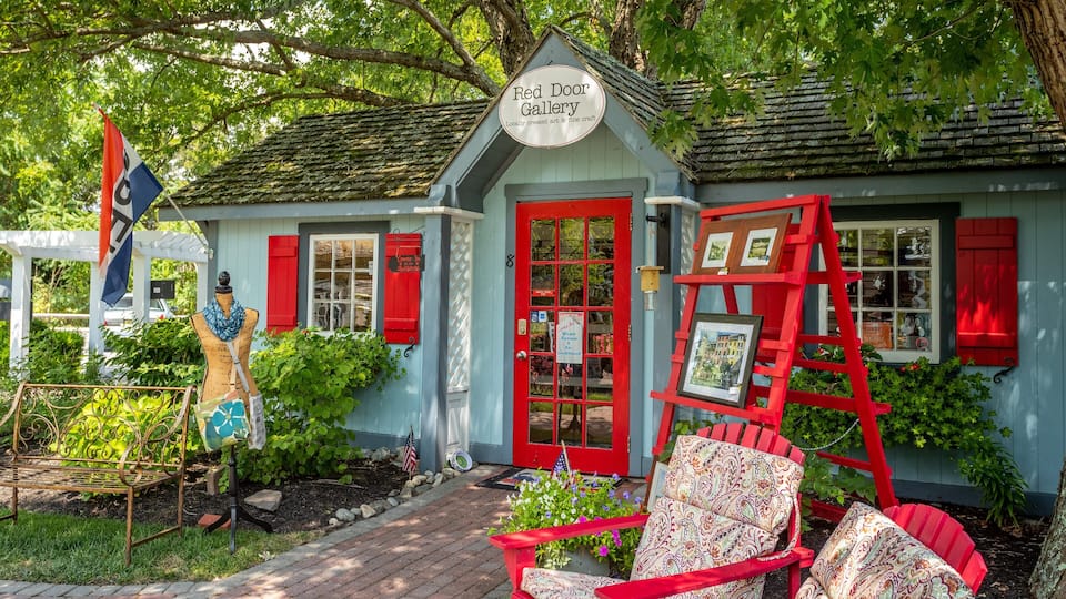 A Red Door Gallery with a red door, red shutters, and a sign indicating locally created art & fine craft.