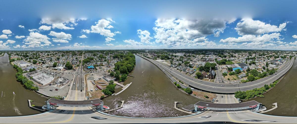 A river with a bridge and a cityscape.