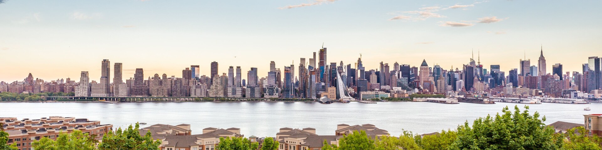 New York City midtown Manhattan skyline panorama view from Boulevard East Old Glory Park over Hudson River.