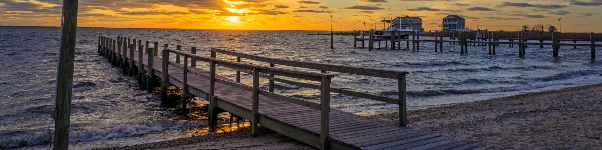 A wood dock on A Bay in New Jersey at Sunrise time