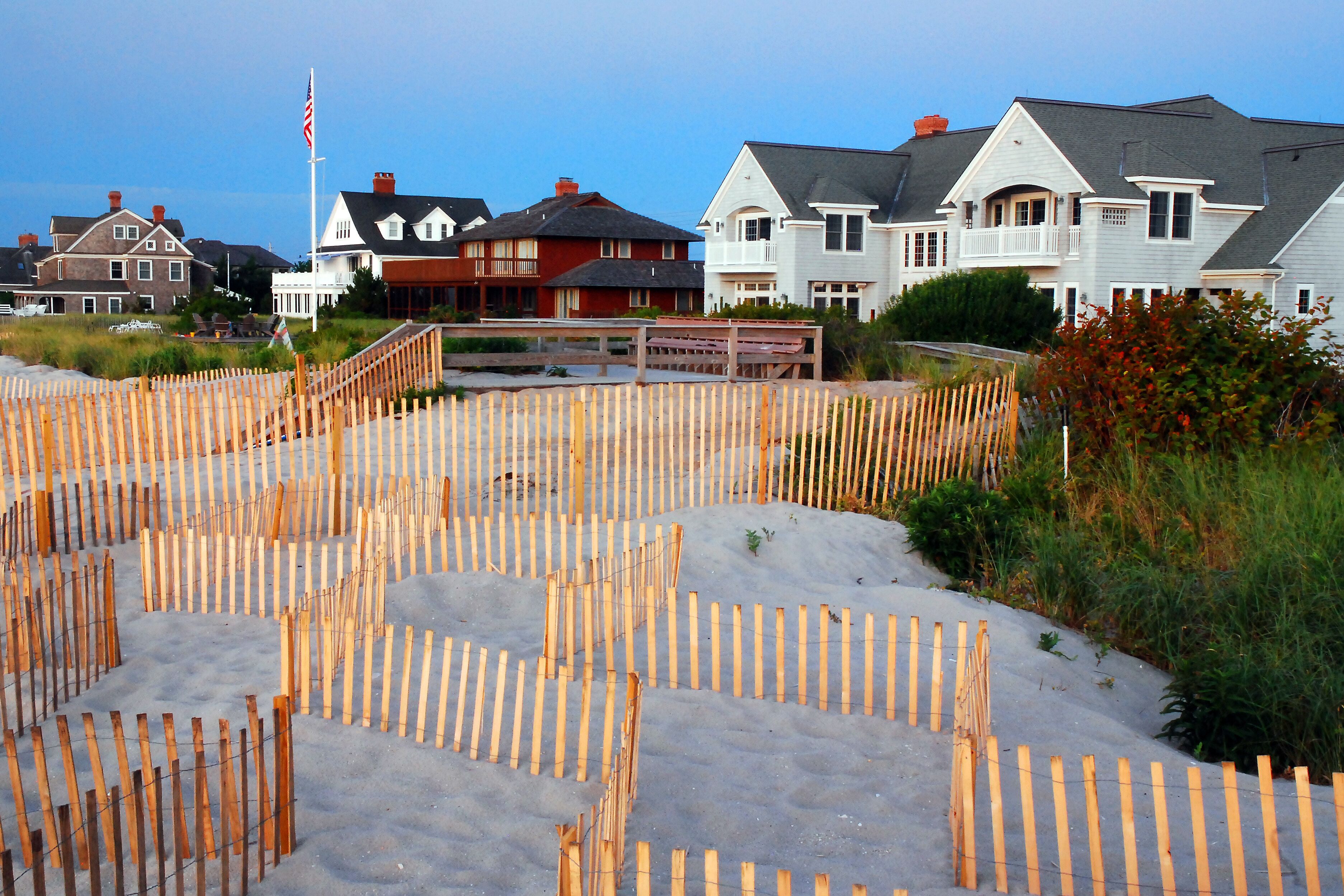 Summer vacation beach homes stand at the edge of the sand dunes on the Jersey Shore