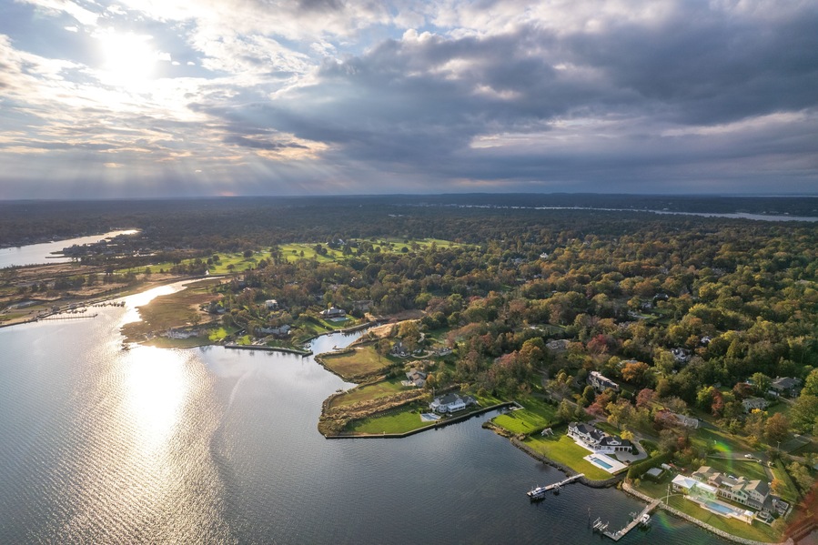A lake surrounded by residential areas and dense forest.